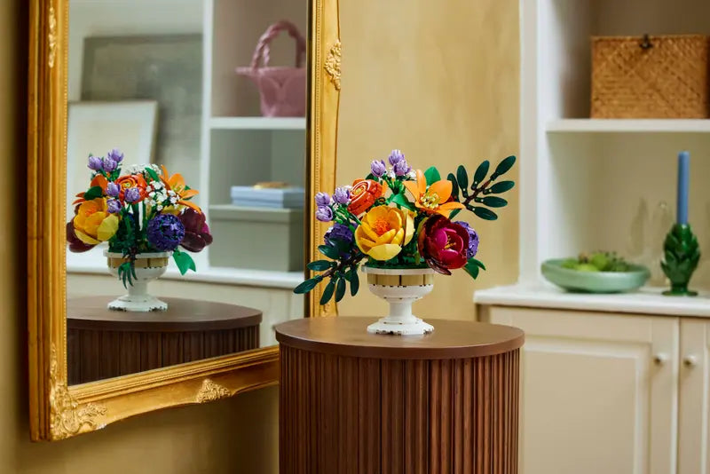 LEGO® Botanicals Flower Arrangement 10345 displayed on a table next to a mirror