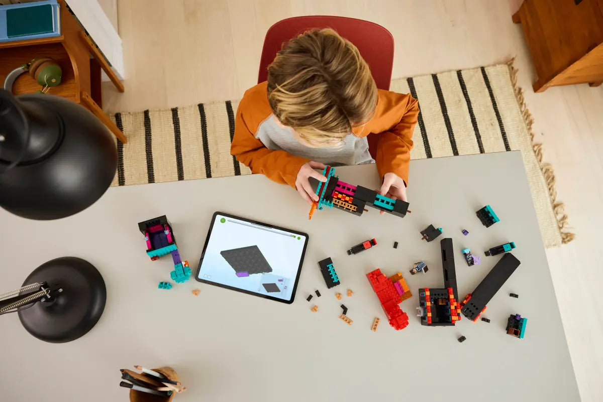 A kid building a LEGO Minecraft Enderman Tower and Fortress 21279