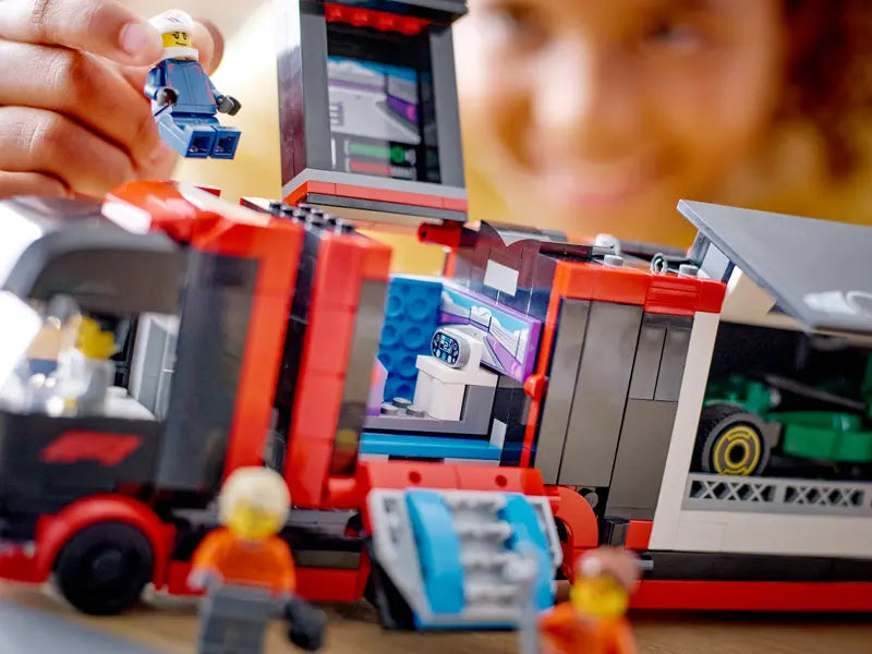 LEGO City F1 Truck with RB20 & AMR24 F1 Cars 60445 features a detachable low-loader trailer with an F1 simulator room