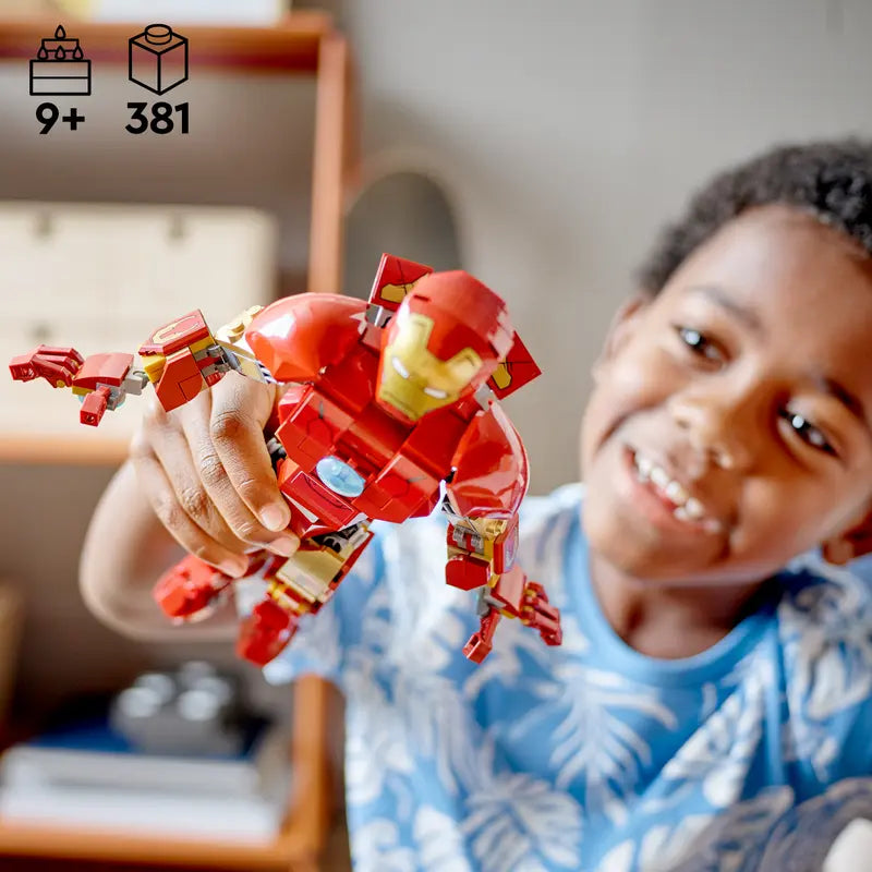 A kid playing with LEGO 76206 Marvel Iron Man Figure