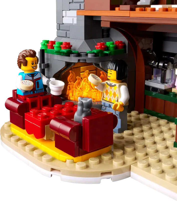 LEGO® ICONS Alpine Lodge 10325   Press the chimney to illuminate the log fires in the reception and second-floor guest room