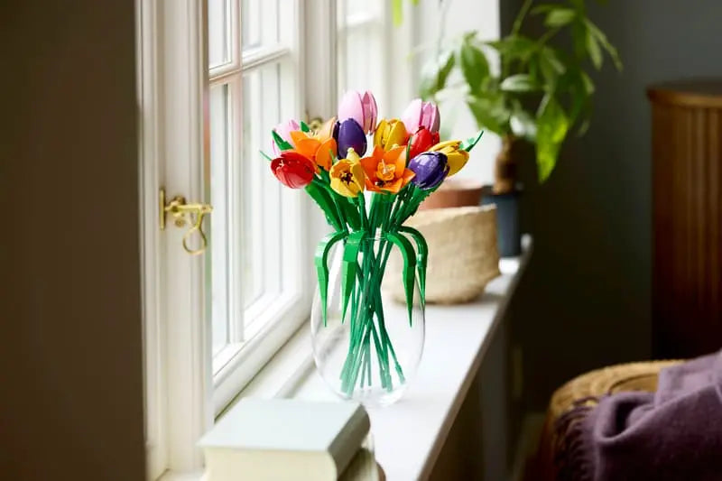 LEGO® Botanicals Tulip Bouquet 11501 displayed in a clear vase next to a window