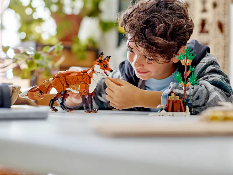 Kid playing with LEGO Creator 3in1 Forest Animals: Red Fox 31154