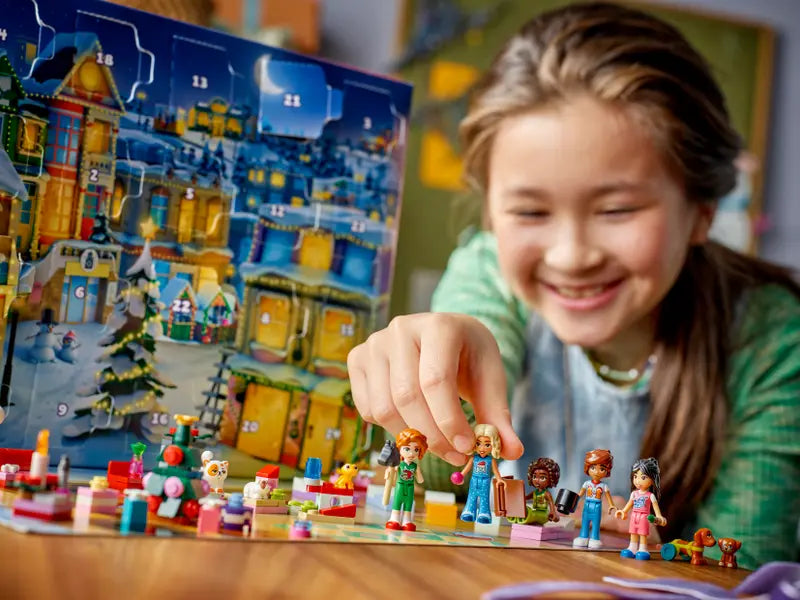 Kid playing with LEGO® Friends 42668 Advent Calendar 2025