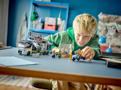 Kid playing with LEGO City Police Mobile Crime Lab Truck 60418