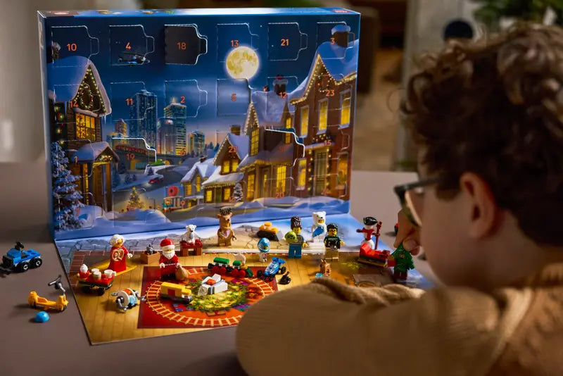 Kid looking at the LEGO® City 60475 Advent Calendar 2025 packed with 24 gifts