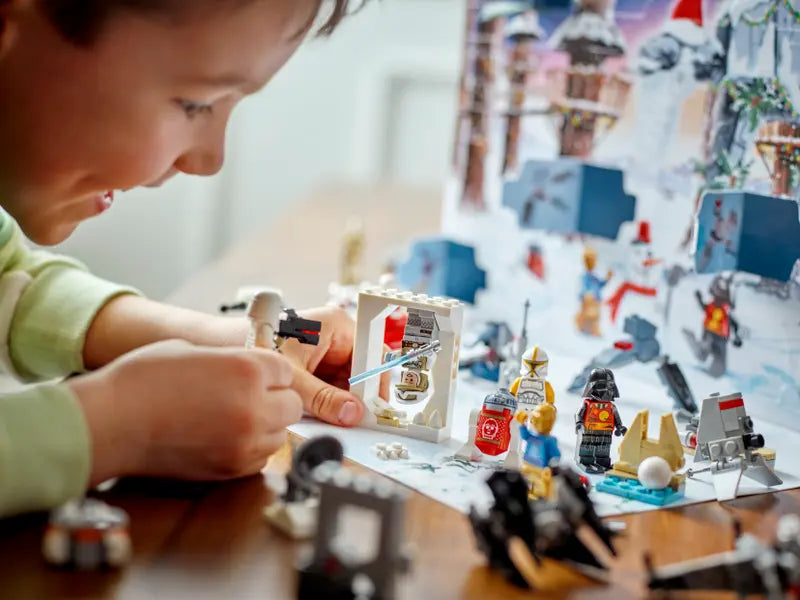 Kid playing with LEGO Star Wars 75340 Advent Calendar 2022 