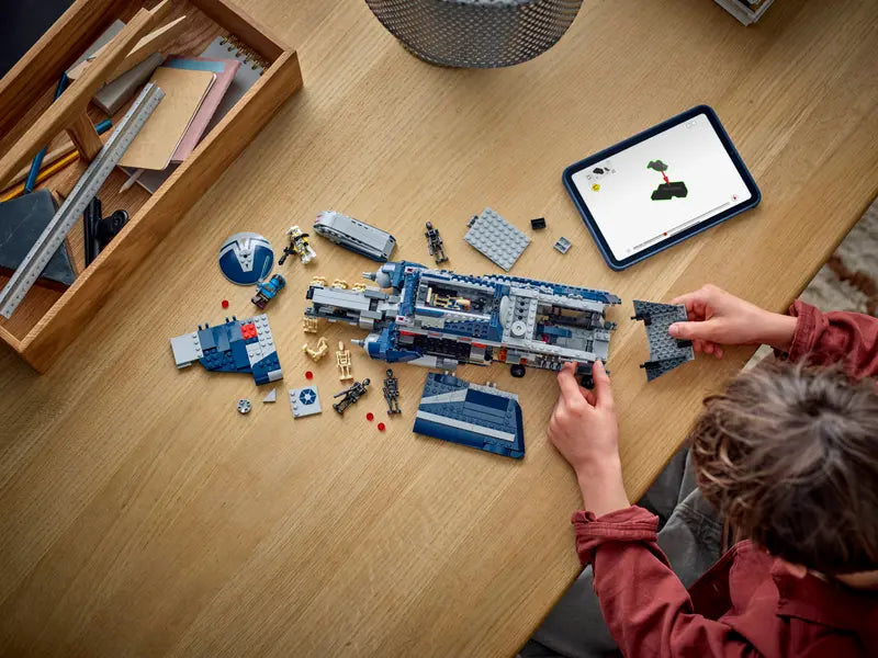 A kid building LEGO Star Wars 75435 Battle of Felucia Separatist MTT